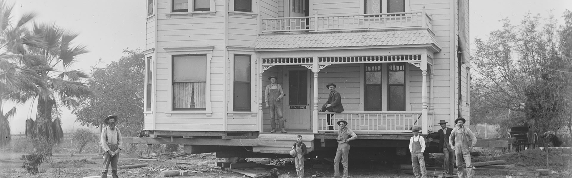 Builders working on the foundation of a new home at the turn of the century.